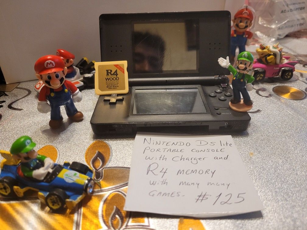 NINTENDO DS LITE PORTABLE CONSOLE WITH CHARGER AND. R4. MEMORY WITH. OVER 110 CLASSIC GAMES IN SIDE