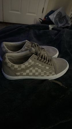 Vans Old Skool sneakers feature a gray checkerboard pattern and a suede upper