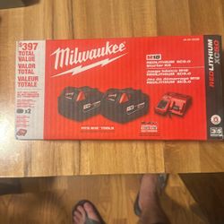 Two 5 Hour Milwaukee Batteries And Charger 