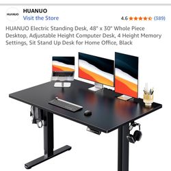 HUANUO Electric Standing Desk, 48" x 30" Whole Piece Desktop, Adjustable Height Computer Desk, 4 Height Memory Settings, Sit Stand Up Desk for Home Of