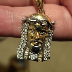 Gold chain with diamond pendant.