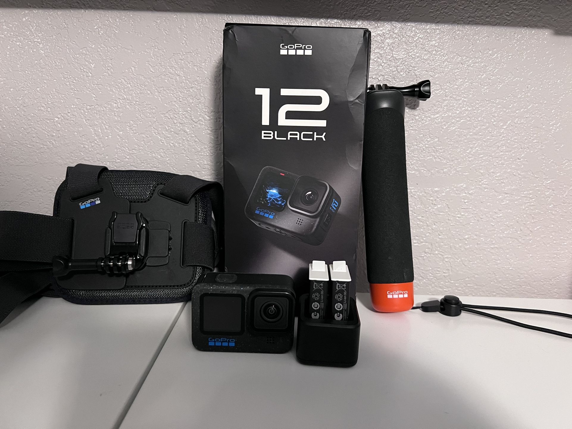 GoPro hero 12. With two extra batteries, a floatable handle and a body strap.