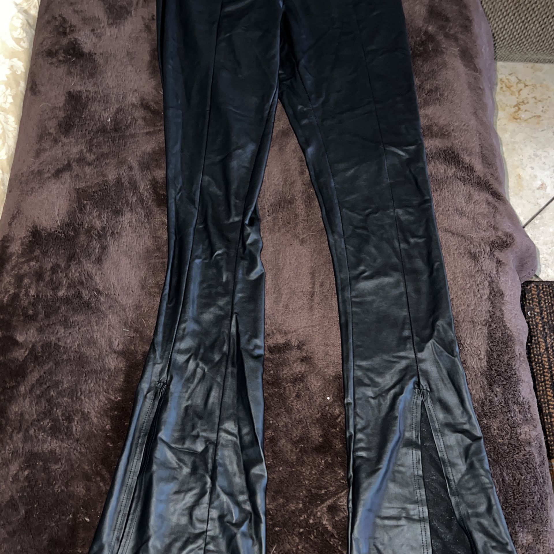 black flare pants with cuts at the bottom