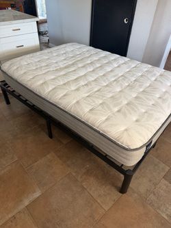 Full-sized bed with frame, Sealy posturepedic mattress, and headboard.