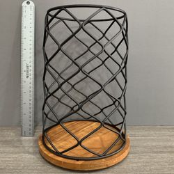 Black metal coffee pod holder with circular design.