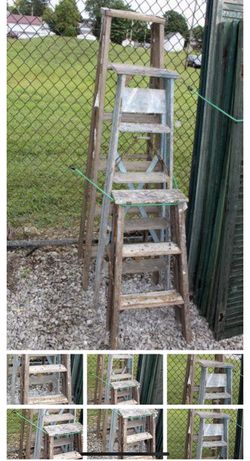 A duo of rustic wooden folding ladders with weathered finishes