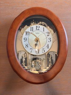 Rhythm Small World Oval Wood/Glass Analog Musical Wall Clock Pendulum, Arabic