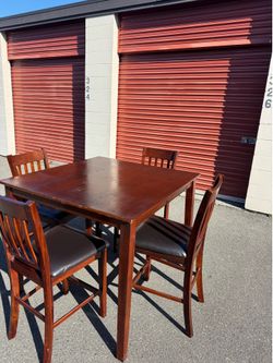 Red wooden high table and four chairs