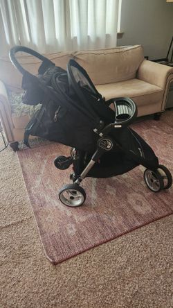 Stroller with ride on attatchment