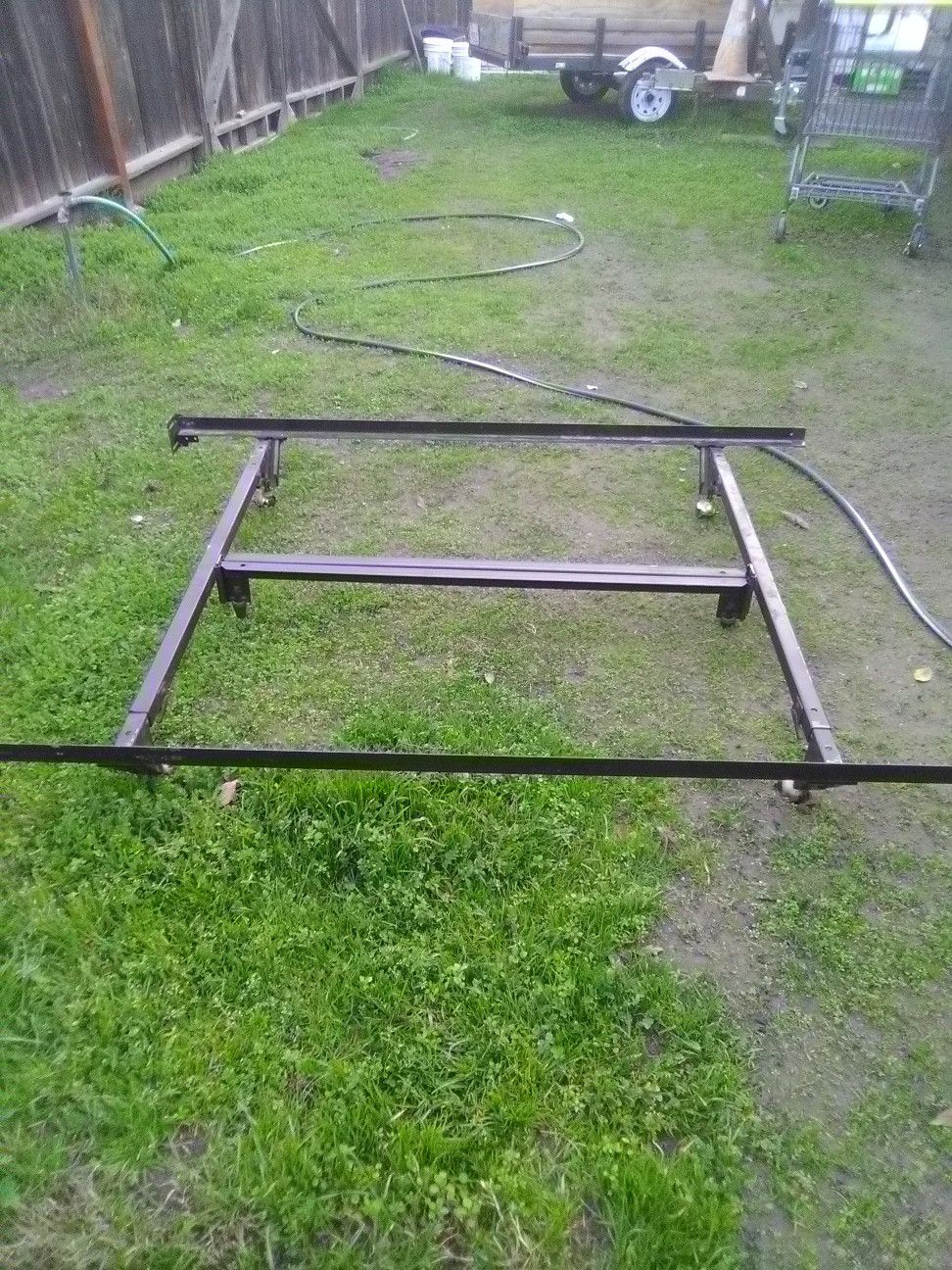 Metal bed frame folds and has wheels for a full size mattress