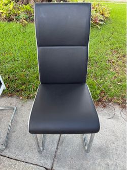 Set of four Cramco CRAM 658-01 dining chairs with black faux leather upholstery and chrome cantilever bases.  Features:  * Set of 4 * Modern contempor