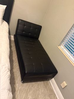 Black tufted faux-leather chaise lounge