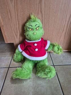 The Grinch wearing a red and white Santa-style jacket by  Build-A-Bear Workshop