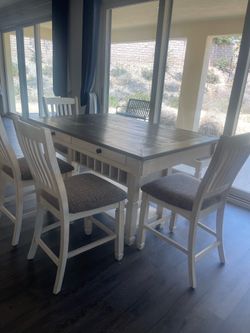 Ashley dining table with four chairs banch and side board buffet wall frames all set