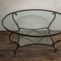 DISCOUNTED PRICE FOR TODAY oval glass-top coffee table with a wrought iron base in Great Condition