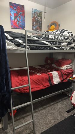 Bunk beds with attached desk, stairs, mattresses included.