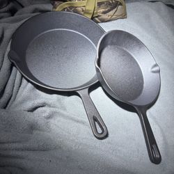 Three brand new cast iron pans