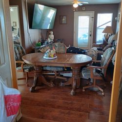Solid Wood Table With Lion Arm Base And Rolling Arm Chairs