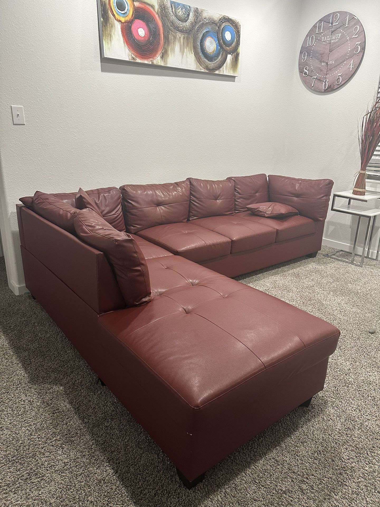 Red Leather Sectional And Wall Pictures