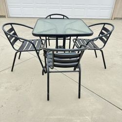Patio Furniture Set Black Metal Tempered Glass Table and 4 Metal Chairs - Like New