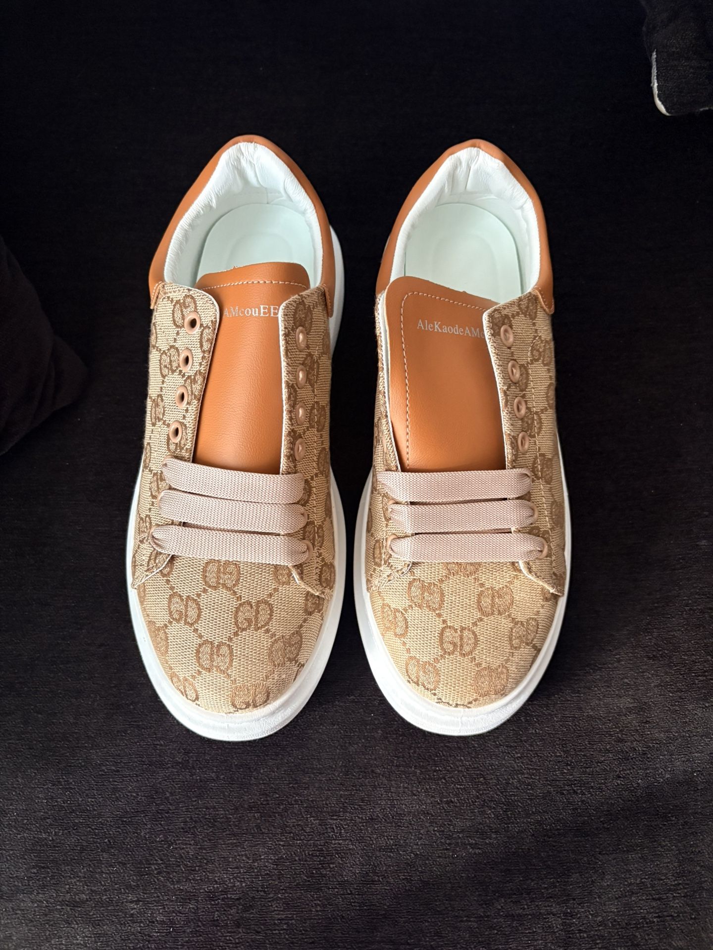 Gucci sneakers with a GG monogram canvas and leather trim