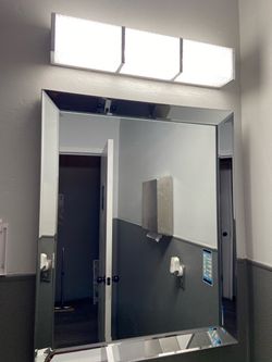 Beveled Wall Mirror with Chrome Frame and bathroom light