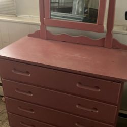 Pink dresser with a mirror