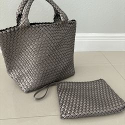 Beautiful bag in metalic color with separate pouch. Never used.  Woth handles 16” high and 13” wide. 