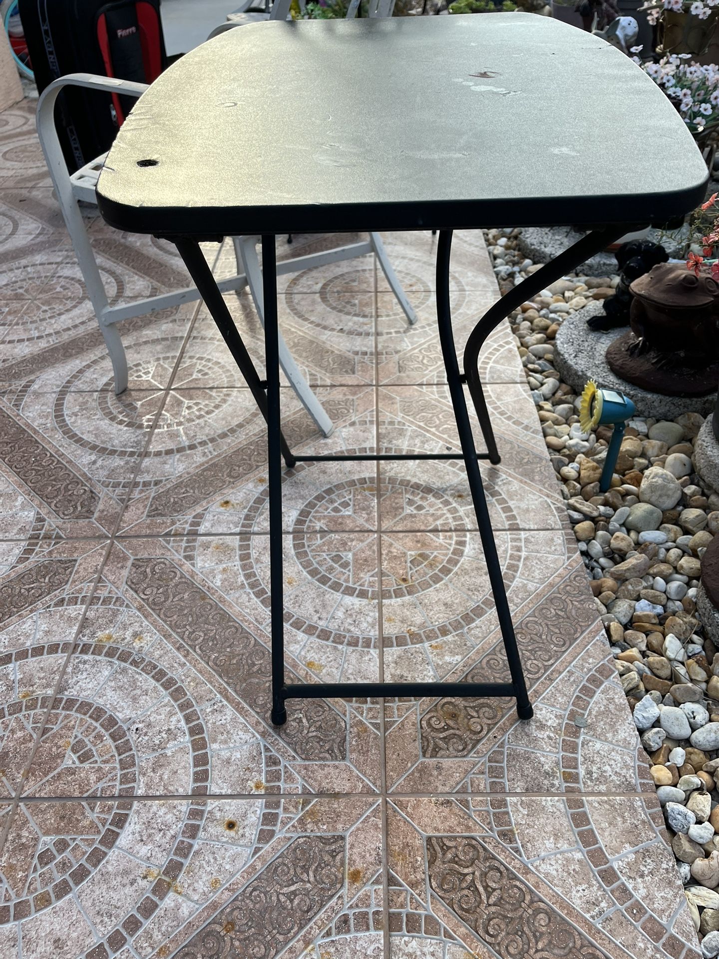Easy-to-assemble collapsible table. It has 3 height settings. The table measures 26 inches long and 17 1/2 inches wide.