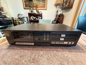 Vintage Technics RS-D400 stereo cassette deck is a black audio component with a front-loading tape compartment. It has a digital peak level meter, a t