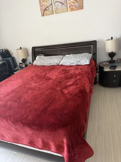 Dark brown queen bedroom set with storage bed, dresser with mirror, and two nightstands.
