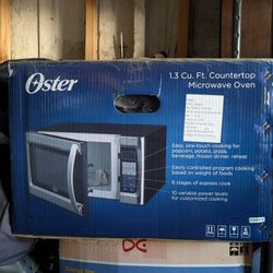 Oster 1.3 Cu. Ft. 1100 Watt Countertop Microwave Oven stainless steel and black