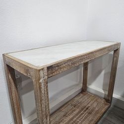 rustic narrow console/entryway table (wood frame + faux marble or stone-look top, with a lower shelf)