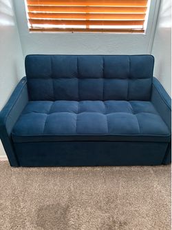 Blue velvet sleeper loveseat couch.