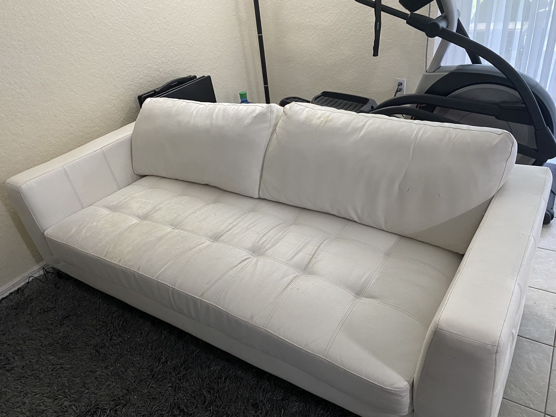 White leather couch set and coffee tables