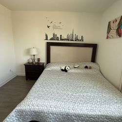 Bed, mattress, nightstand, and cabinet.