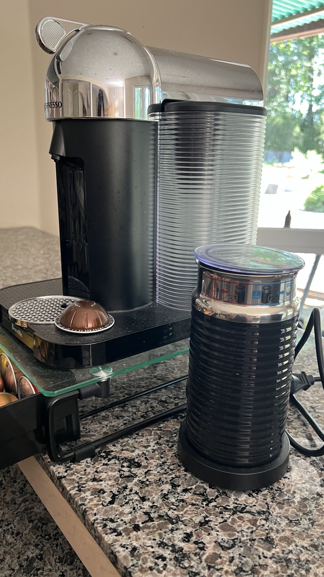 Nespresso Vertuo Coffee and Espresso Machine with tray and capsules