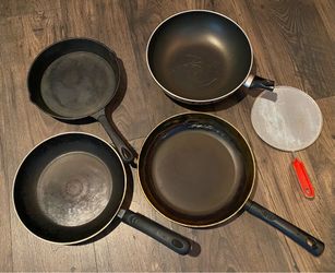 5 used pans, one of the cast iron