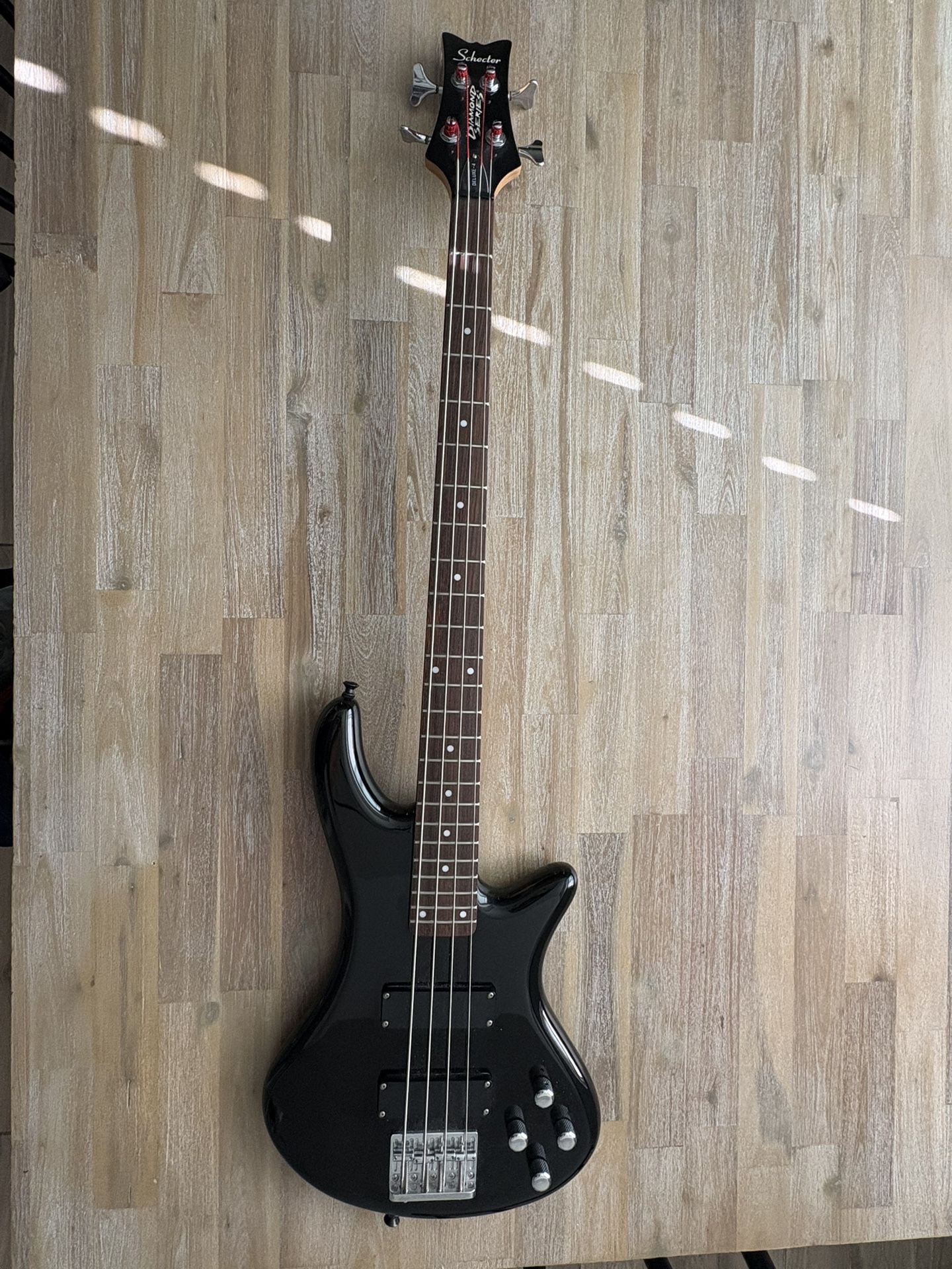 A used Schecter Guitar Research DIAMOND SERIES STILETTO DELUXE 4 Black Electric Bass Guitar