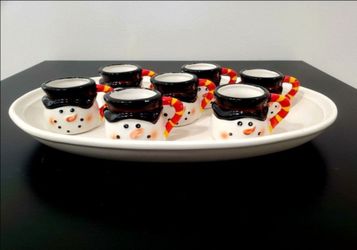 Miniature mugs featuring a handmade snowman design and white earthenware oval platter by Bee & Willow.