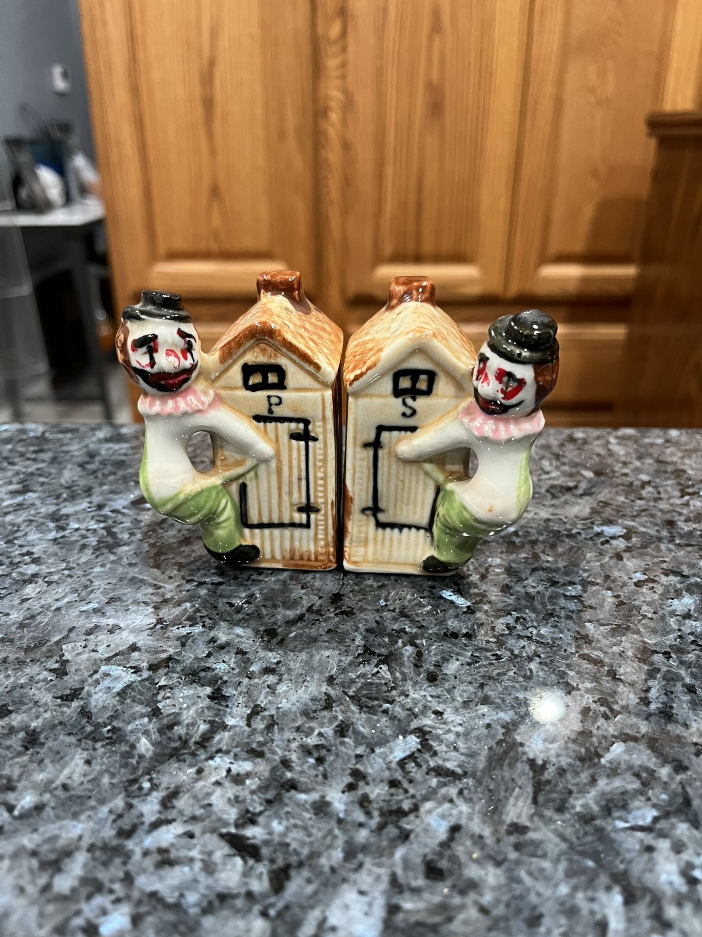 Vintage Hobo on an Outhouse Salt and Pepper Shakers.  Size approximately 3 inches tall.  Preowned Good Condition. 