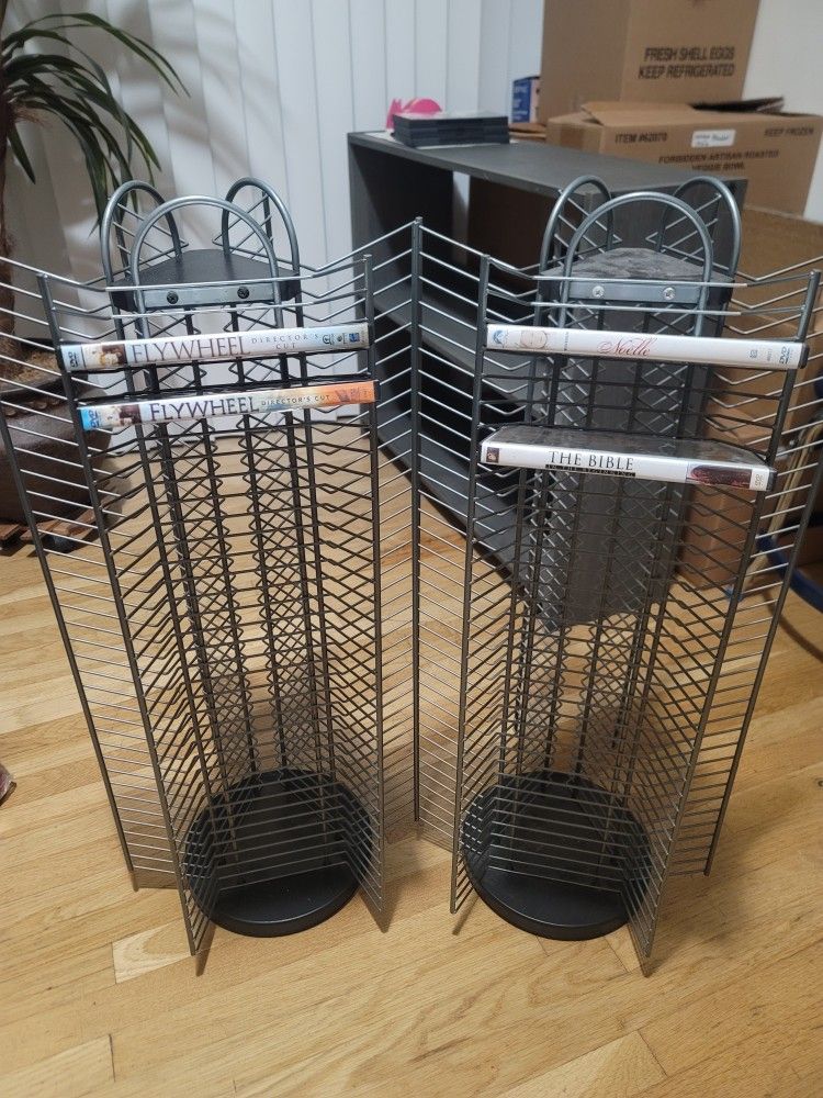 2 DVD HOLERS PLUS THEY SWIVEL IN GOOD CONDITION EACH ONE HOLDS 105 DVDS SELLING TOGETHER AS A SET
