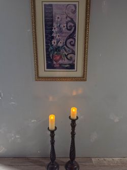 Solid wood candlesticks with candles.