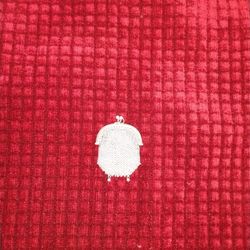 The item in the image is a vintage or antique silver mesh coin purse. These small bags are typically made of woven metal links, often sterling silver 