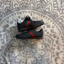 Black leather gucci shoes with and green stripe