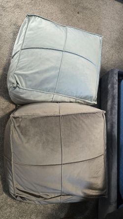 Two velvet poufs
