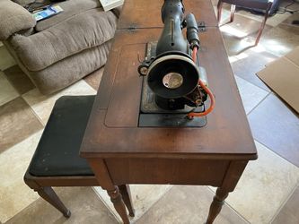 Vintage Singer sewing machine with cabinet, stool and sewing supplies