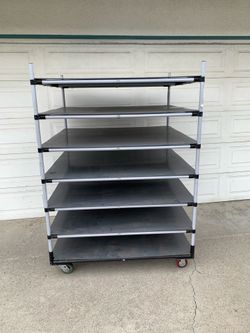 METAL RACK/ SHELVES WITH PLASTIC PLY SHEETS ON IT