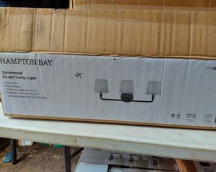 Hampton bay canterwood 3 light bathroom vanity light fixture in light brass withbfabric shades, few available