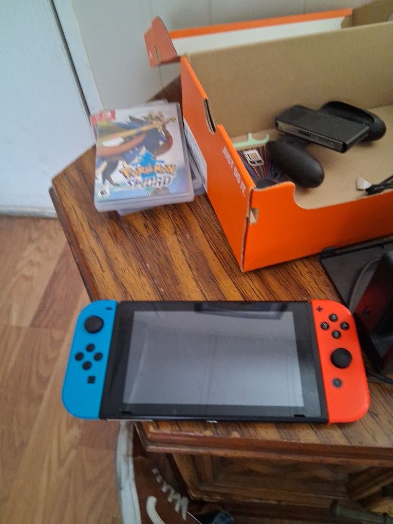 Nintendo Switch, Charge Deck And Joy Cons.